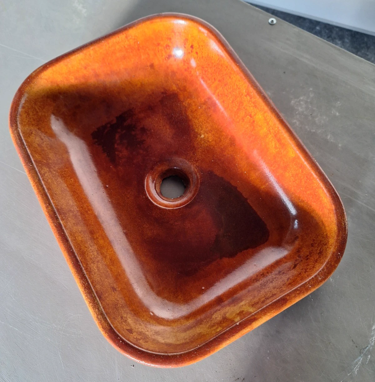 Concrete sink with orange glaze finish